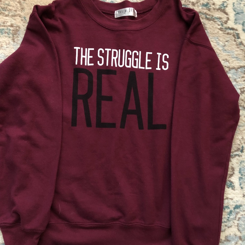 Maroon sweat that says “The struggle is real